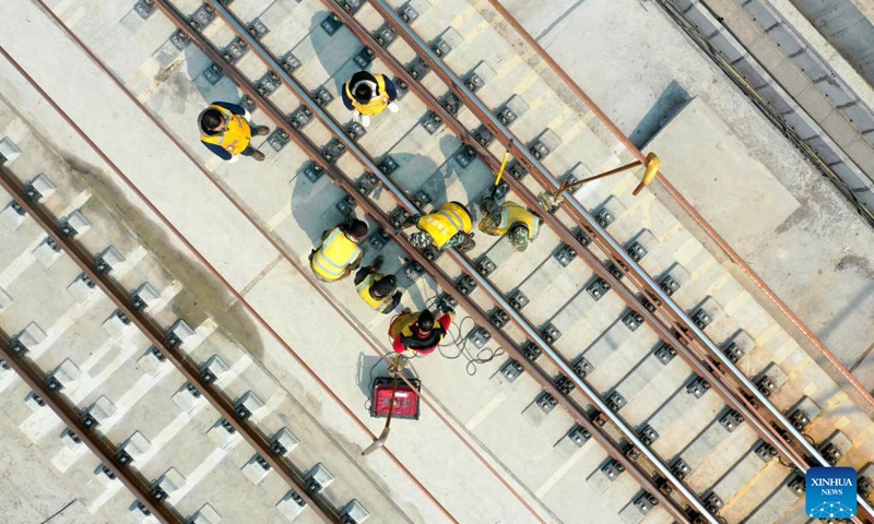 This aerial photo taken on Feb. 27, 2023 shows technicians conducting fine adjustment work of rail tracks near the Duyun East Railway Station along Guiyang-Nanning high-speed railway in Duyun, southwest China's Guizhou Province. The Guiyang-Nanning high-speed railway, with a maximum speed of 350 km per hour, is expected to go into service in 2023.(Photo: Xinhua)