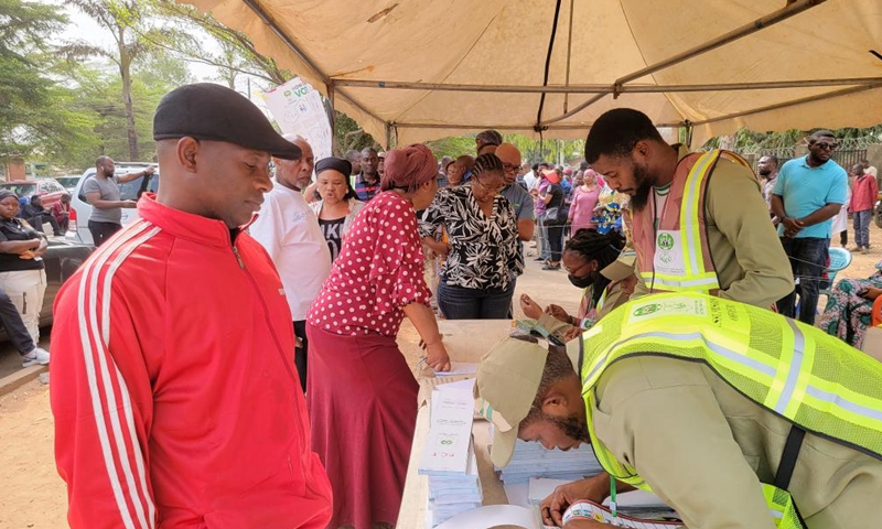 Staff members distribute ballot papers at a polling station in Abuja, Nigeria, on Feb. 25, 2023. Nigeria's presidential and parliamentary elections kicked off Saturday as voters went to the polls nationwide to elect a new president and members of the national assembly. (Xinhua/Guo Jun)