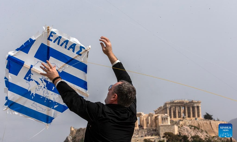 A man tries to fly a kite on the occasion of Clean Monday at Filopappou Hill in Athens, Greece, on Feb. 27, 2023.(Photo: Xinhua)