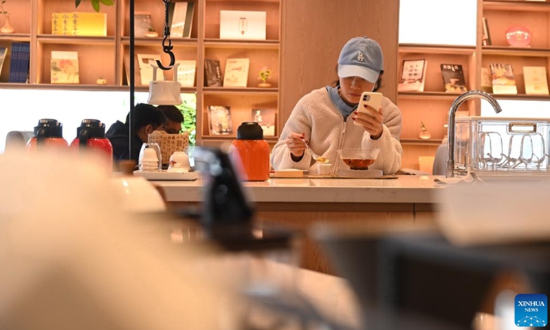 People enjoy their leisure time at a tea house in Suning Plaza in Fuzhou, southeast China's Fujian Province, Feb. 26, 2023. The time-honored tea culture has contributed to the thriving of tea houses in Fuzhou.(Photo: Xinhua)