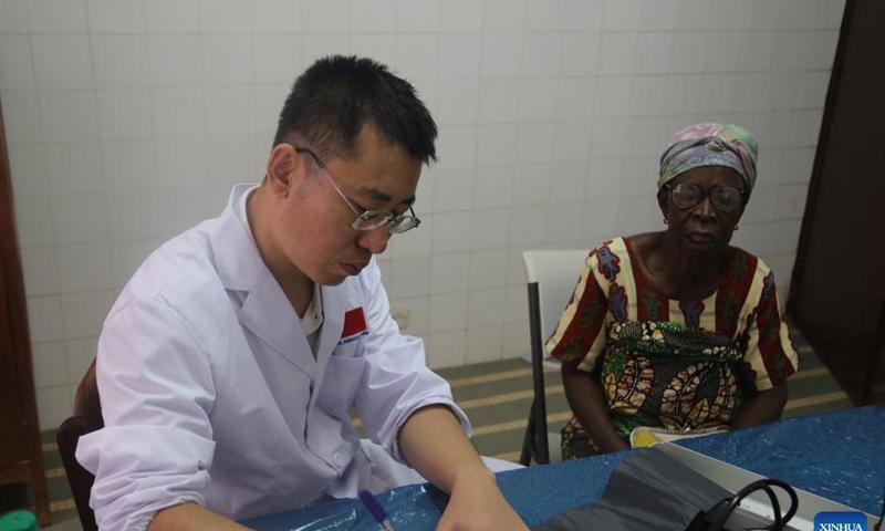 A member of the 25th Chinese medical team dispatched to Togo inquires a local patient at the Medical Center of Pya in Kara, Togo, Feb. 25, 2023. The 25th Chinese medical team dispatched to Togo on Saturday provided free medical services for more than 600 local patients at the Medical Center of Pya in Kara and donated medical supplies. The medical services included internal medicine, general surgery, obstetrics and gynecology, orthopedics, and traditional Chinese acupuncture. (Xinhua)