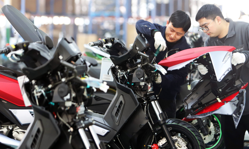 Workers rush to make motorcycles for clients at home and abroad at a factory in Jinqing town, East China's Zhejiang Province, on March 2, 2023. With its independent industrial chain, Zhejiang Jinlang Power Co exports its products to more than 30 countries and regions. Photo: VCG