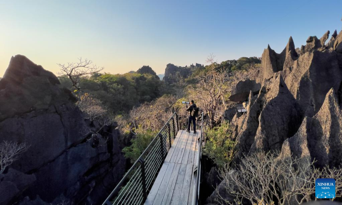 A tourist takes pictures at the Rock Viewpoint in Khounkham District, Khammouane Province, Laos, Feb 26, 2023. The Rock Viewpoint is one of the top attractions in the Khammouane Province of Laos. Photo:Xinhua