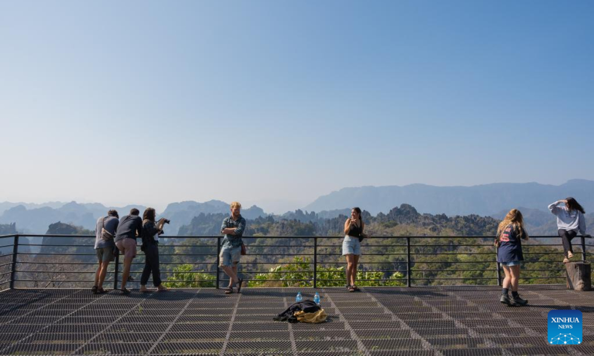 Tourists visit the Rock Viewpoint in Khounkham District, Khammouane Province, Laos, Feb 26, 2023. The Rock Viewpoint is one of the top attractions in the Khammouane Province of Laos. Photo:Xinhua