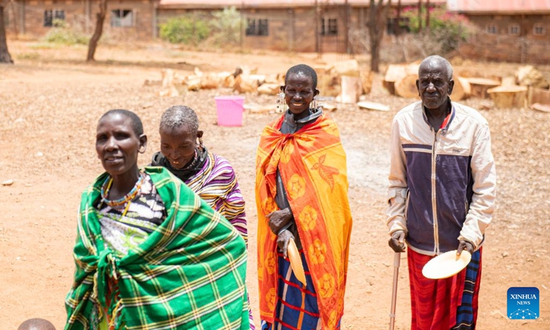 Members of a Maasai family wait for their lunch at a boarding school in Kajiado County, Kenya, Feb. 28, 2023. The Maasai are a Nilotic ethnic group inhabiting central and southern Kenya and northern Tanzania. They rely on livestock breeding as their main source of income.(Photo: Xinhua)