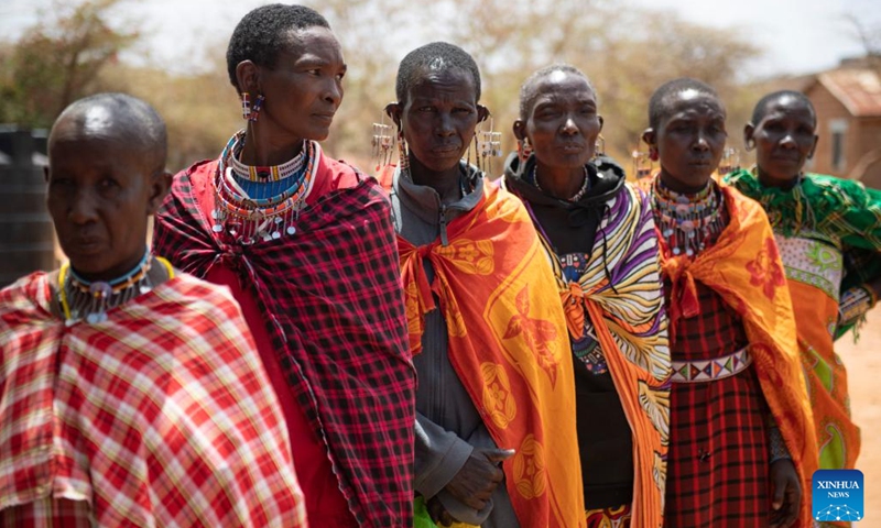 Members of a Maasai family wait for food aid at a boarding school in Kajiado County, Kenya, Feb. 28, 2023. The Maasai are a Nilotic ethnic group inhabiting central and southern Kenya and northern Tanzania. They rely on livestock breeding as their main source of income.(Photo: Xinhua)