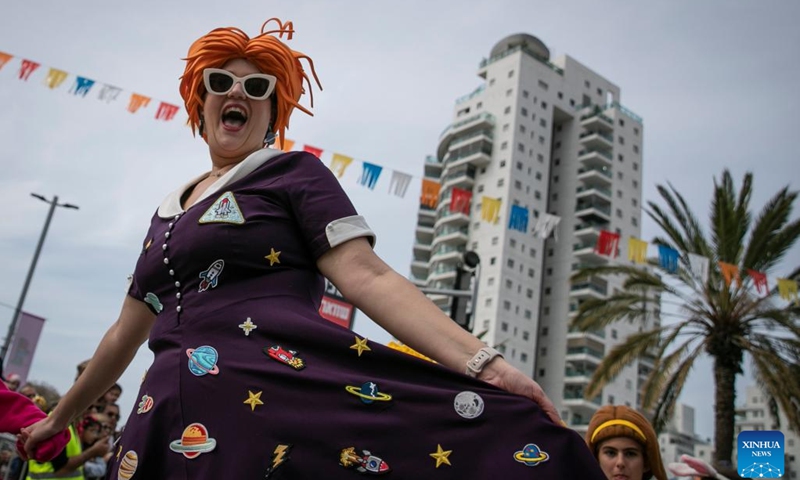 A woman participates in Adloyada Holon Purim Parade 2023 in Holon, central Israel, on March 7, 2023. Purim is a Jewish holiday that commemorates the deliverance of the Jewish people from Haman's plot during the reign of the ancient Persian Empire, according to the Biblical Book of Esther.(Photo: Xinhua)