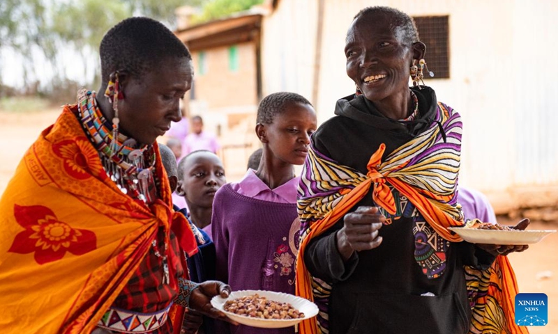 Members of a Maasai family hold plates containing their lunch at a boarding school in Kajiado County, Kenya, Feb. 28, 2023. The Maasai are a Nilotic ethnic group inhabiting central and southern Kenya and northern Tanzania. They rely on livestock breeding as their main source of income.(Photo: Xinhua)