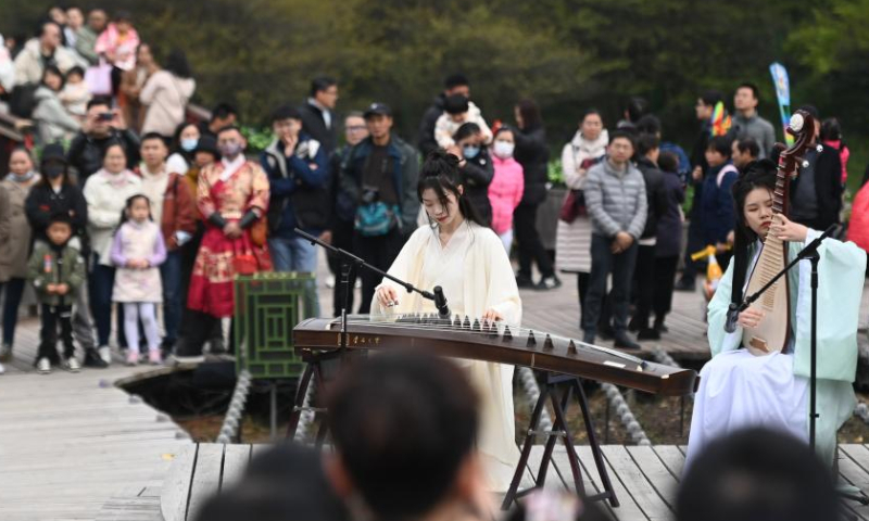 Performers play traditional Chinese musical instruments for visitors at Xixi National Wetland Park in Hangzhou, east China's Zhejiang Province, March 18, 2023. A series of activities was held here Saturday to celebrate a traditional flower festival or Hua Zhao Jie in Chinese. (Xinhua/Huang Zongzhi)