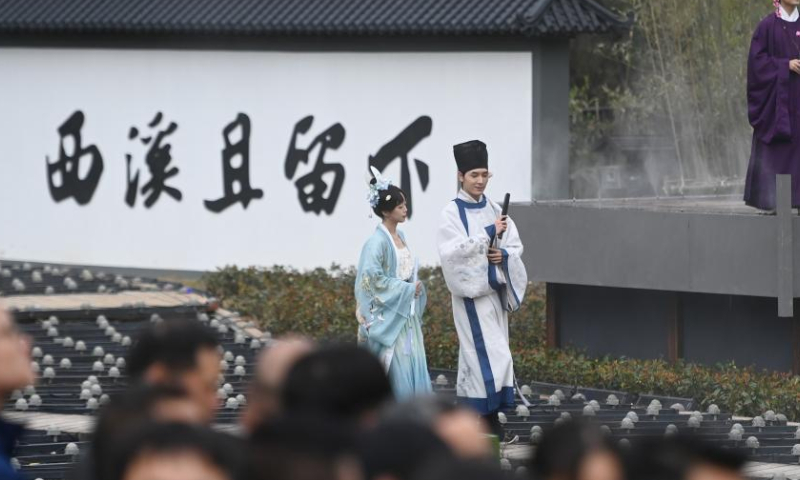 Actors in olden costumes perform for visitors at Xixi National Wetland Park in Hangzhou, east China's Zhejiang Province, March 18, 2023. A series of activities was held here Saturday to celebrate a traditional flower festival or Hua Zhao Jie in Chinese. (Xinhua/Huang Zongzhi)