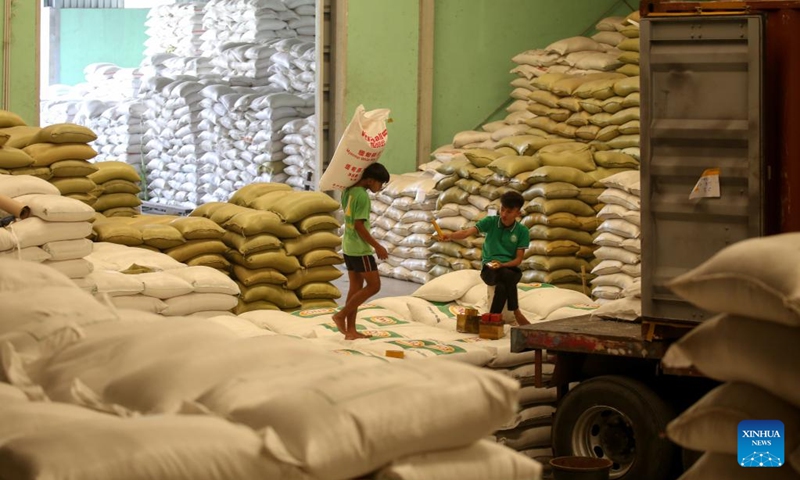 A worker carries a package of rice at a warehouse in Yangon, Myanmar, March 8, 2023. Myanmar exported 106,855 tons of rice in February this year, as compared to 171,811 tons of rice exported in January, the Myanmar Rice Federation (MRF) said on Tuesday.(Photo: Xinhua)