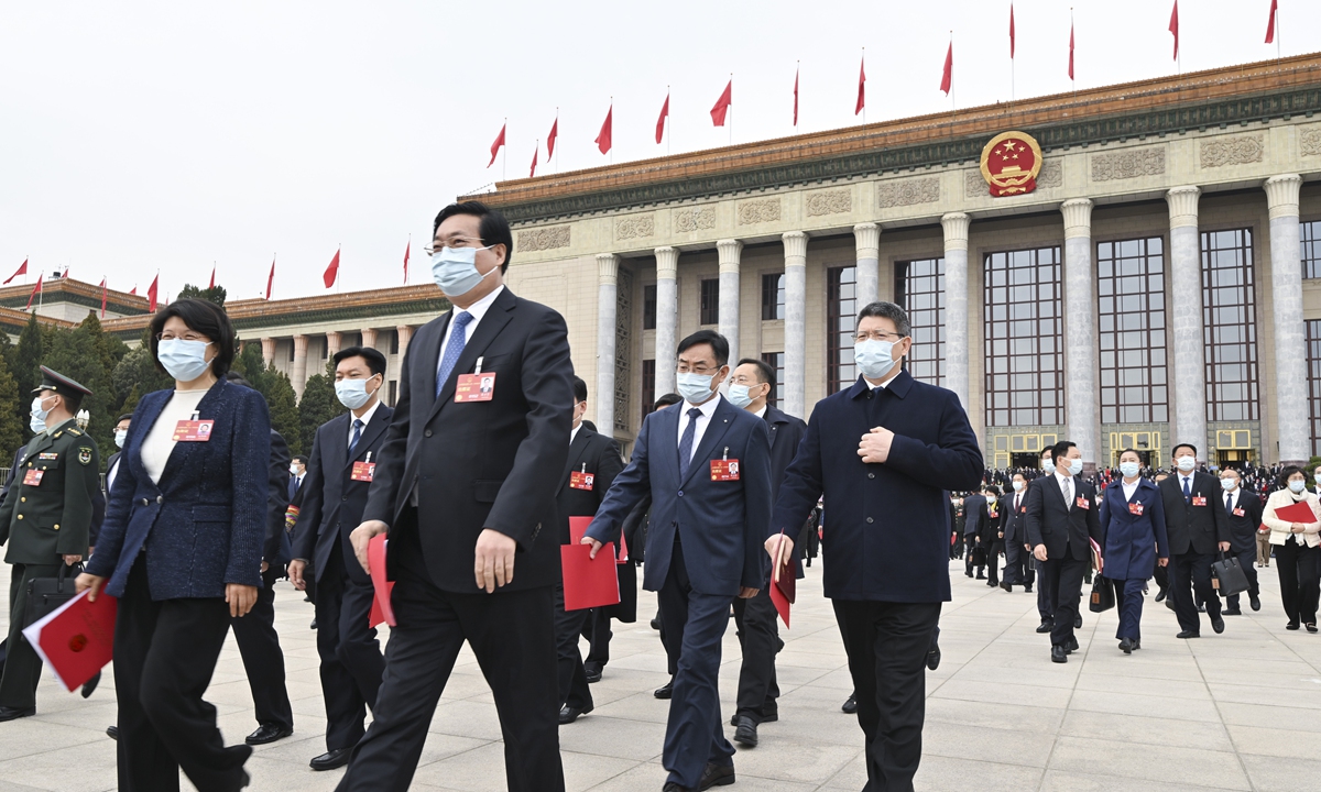 Deputies to the 14th National People's Congress (NPC) leave the Great Hall of the People in Beijing after the closing meeting of the first session of the 14th NPC on Monday. Photo: Xinhua