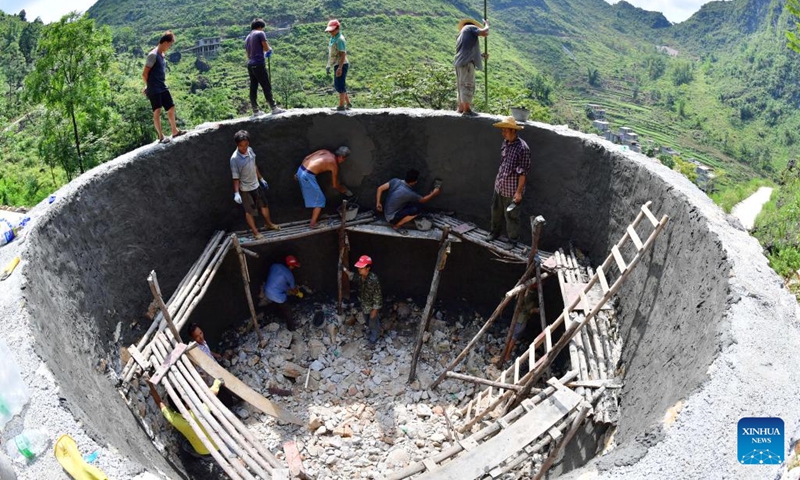 This photo taken on Sept. 2, 2017 shows villagers building a household water tank in Nongyong Village of Bansheng Township, Dahua Yao Autonomous County, south China's Guangxi Zhuang Autonomous Region. Situated at the center of the Karst landforms in west Guangxi, Dahua Yao Autonomous County had suffered from severe water deficit for ages.(Photo: Xinhua)