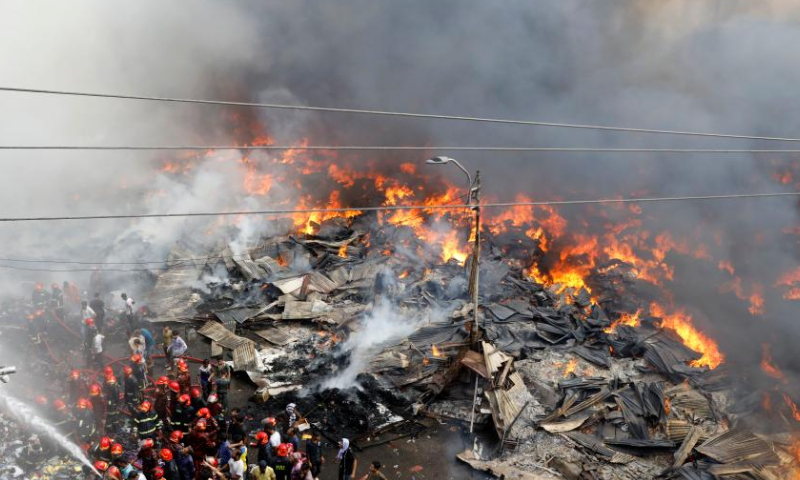 Firefighters battle a fire at a market in Dhaka, Bangladesh, on April 4, 2023. A fire gutted thousands of shops in a market in a residential neighborhood of the old part of Dhaka on Tuesday morning, destroying goods and property. (Xinhua)