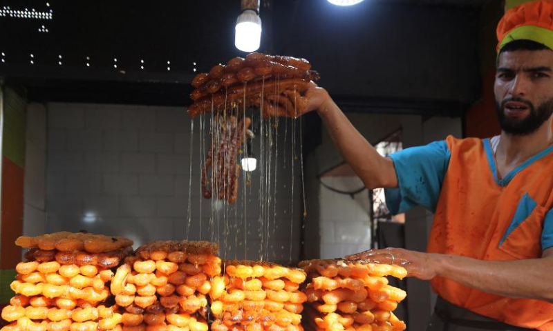 A man makes traditional dessert known as Zalabia during Ramadan in Boufarik, Algeria, on March 28, 2023. (Xinhua)