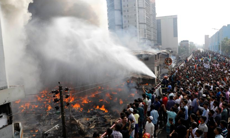 People gather at the site where a fire broke out at a market in Dhaka, Bangladesh, on April 4, 2023. A fire gutted thousands of shops in a market in a residential neighborhood of the old part of Dhaka on Tuesday morning, destroying goods and property. (Xinhua)