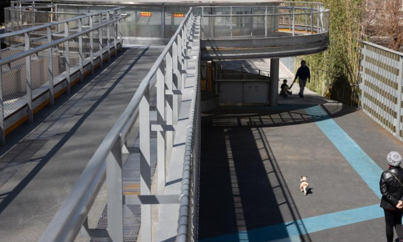 Pedestrians enjoy leisure time in the Baixi Park in Putuo District of Shanghai, east China, March 13, 2023. With the construction of pocket parks, boulevard networks, green wedges, urban greenbelts and the like, Shanghai has been vigorously expanding its public ecological space. (Xinhua/Jin Liwang)