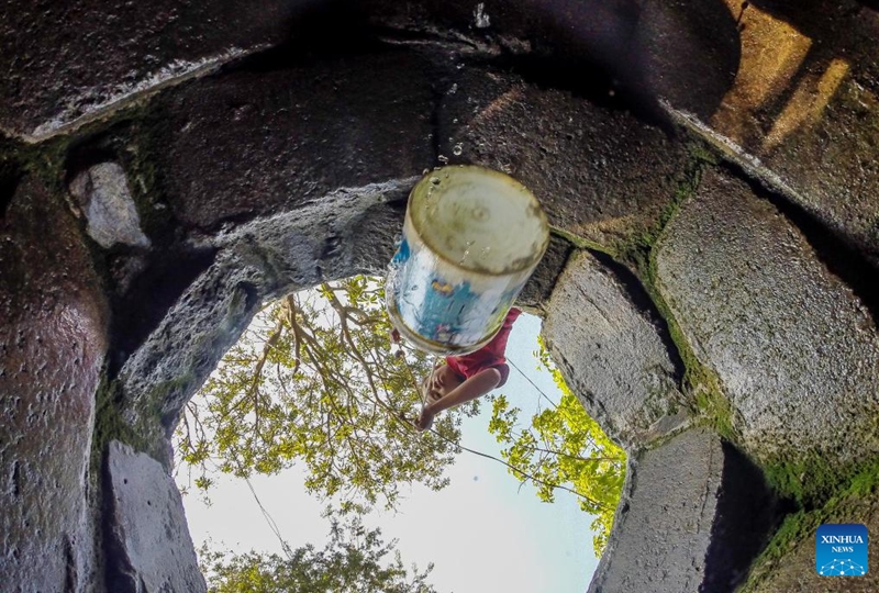 A resident fetches water from a well at a residential area on the occasion of World Water Day in Quezon City, the Philippines, March 22, 2023. (Xinhua/Rouelle Umali)