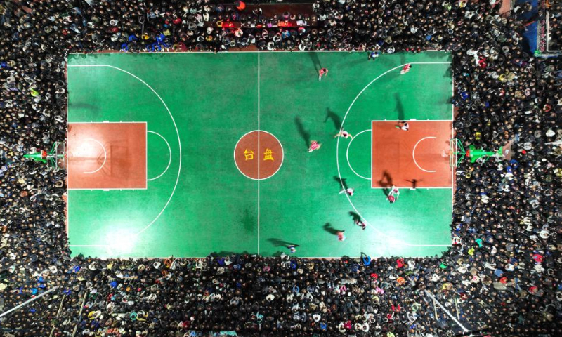 An areial photo taken on March 25, 2023 shows a basketball game between Team Tongren and Team Qiandongnan held in Taipan Village, Taijiang County, southwest China's Guizhou Province. Village Basketball Association or Village BA, is a grassroot basketball tournament held in Taipan Village. Organized by local residents, this event has gained popularity over the years and draws a large crowd of spectators and participants alike. The tournament showcases the passion and skills of basketball players from rural areas, as they compete and demonstrate their teamwork on the court. (Xinhua/Ou Dongqu)

