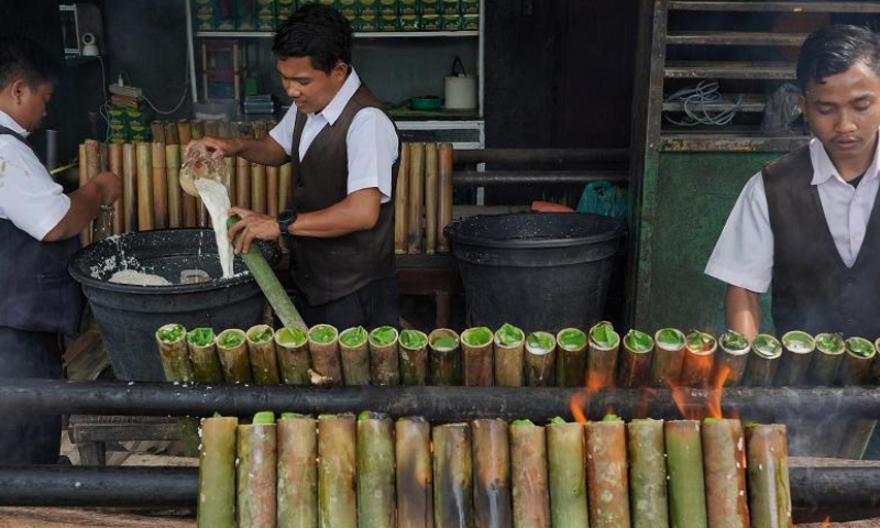 Workers make lemang, a traditional food made of glutinous rice cooked in hollowed bamboo sticks, during Ramadan in Medan, North Sumatra, Indonesia, on April 1, 2023. (Photo by Harry Reira/Xinhua)