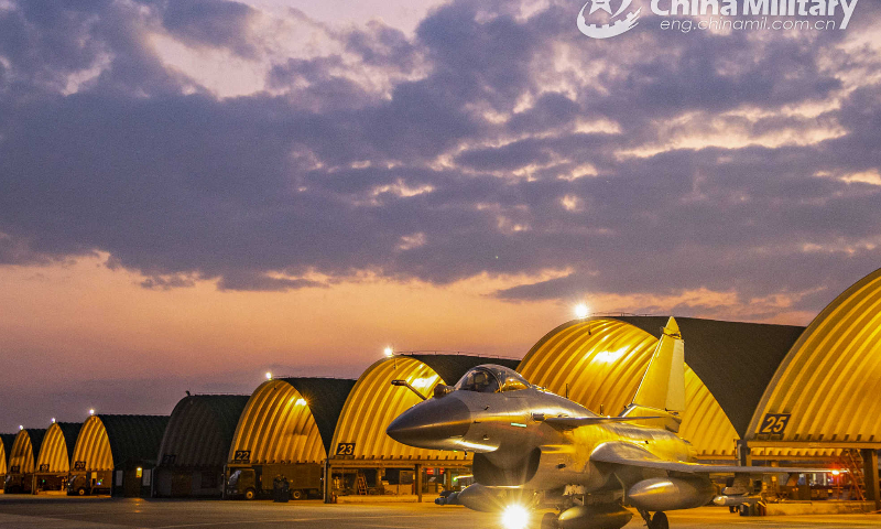 A fighter jet attached to an aviation brigade of the air force under the PLA Southern Theater Command taxies out of the hangar before a recent real combat training exercise. (eng.chinamil.com.cn/Photo by Wang Guoyun)