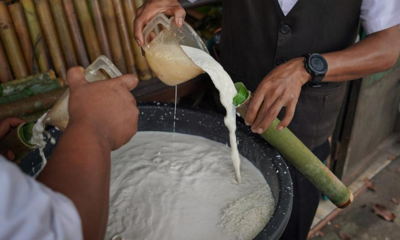 Workers make lemang, a traditional food made of glutinous rice cooked in hollowed bamboo sticks, during Ramadan in Medan, North Sumatra, Indonesia, on April 1, 2023. (Photo by Harry Reira/Xinhua)