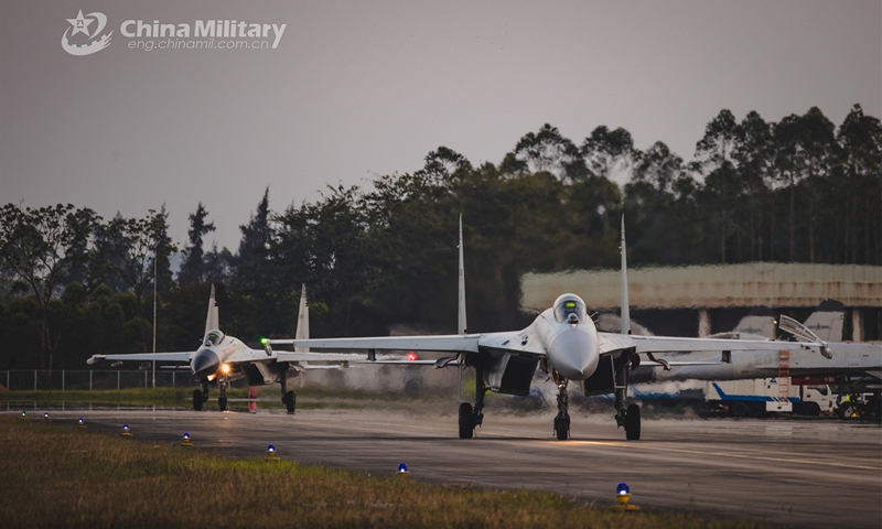 Fighter jets attached to a naval aviation brigade under the PLA Southern Theater Command taxi out of the hangar and get prepared to take off for a day-and-night flight training exercise in early March, 2023. (eng.chinamil.com.cn/Photo by Fu Jinquan)