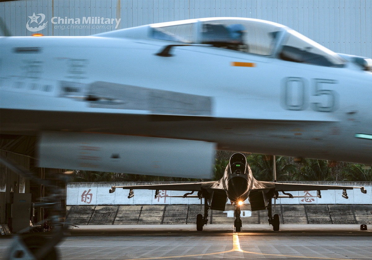 Fighter jets attached to a naval aviation brigade under the PLA Southern Theater Command taxi out of the hangar and get prepared to take off for a day-and-night flight training exercise in early March, 2023. (eng.chinamil.com.cn/Photo by Fu Jinquan)