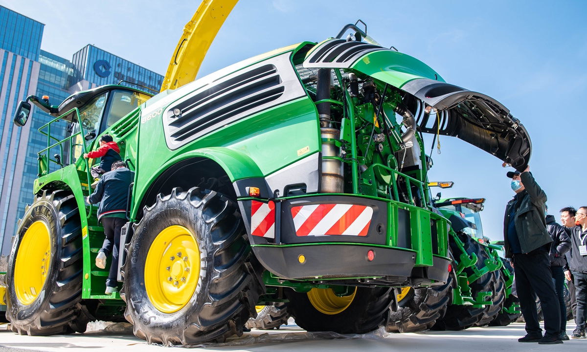 People check out a silage harvester on display at an agricultural and animal husbandry machinery exhibition in Hohhot, North China's Inner Mongolia Autonomous Region, on March 26, 2023. The three-day expo attracted over 500 exhibitors, showcasing more than 3,000 types of agricultural machinery. Photo: VCG