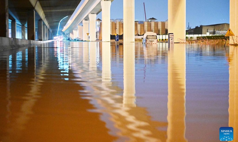 This photo taken on March 26, 2023 shows a vehicle submerged in flood water in Capital Governorate, Kuwait. (Photo by Asad/Xinhua)