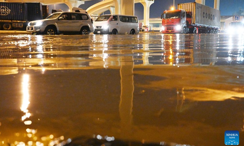 This photo taken on March 26, 2023 shows vehicles drive on a flooded street in Capital Governorate, Kuwait. (Photo by Asad/Xinhua)