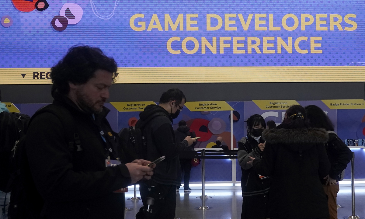 Attendees stand near the registration desk at the Game Developers Conference 2023 in San Francisco on March 21, 2023. Photo: VCG