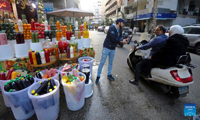 Juice vendors promote their products in Beirut, Lebanon, on March 26, 2023. (Xinhua/Bilal Jawich)