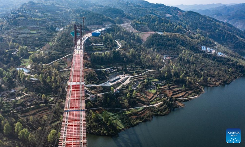 This aerial photo taken on March 30, 2023 shows the Wujiang grand bridge, a main project on the expressway linking Dejiang and Yuqing, in southwest China's Guizhou Province. The main body of the Wujiang Bridge was completed on Thursday. The bridge, located at the junction of Sinan, Shiqian and Fenggang counties of Guizhou Province, features a length of 1,834 meters and a span of 504 meters.(Photo: Xinhua)