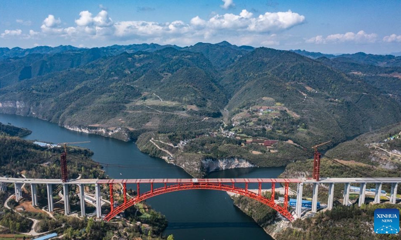 This aerial photo taken on March 30, 2023 shows the Wujiang grand bridge, a main project on the expressway linking Dejiang and Yuqing, in southwest China's Guizhou Province. The main body of the Wujiang Bridge was completed on Thursday. The bridge, located at the junction of Sinan, Shiqian and Fenggang counties of Guizhou Province, features a length of 1,834 meters and a span of 504 meters.(Photo: Xinhua)