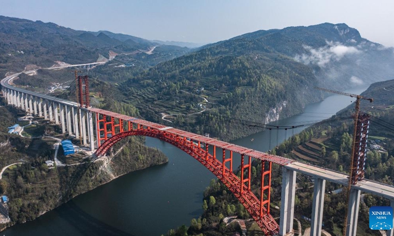 This aerial photo taken on March 30, 2023 shows the Wujiang grand bridge, a main project on the expressway linking Dejiang and Yuqing, in southwest China's Guizhou Province. The main body of the Wujiang Bridge was completed on Thursday. The bridge, located at the junction of Sinan, Shiqian and Fenggang counties of Guizhou Province, features a length of 1,834 meters and a span of 504 meters.(Photo: Xinhua)