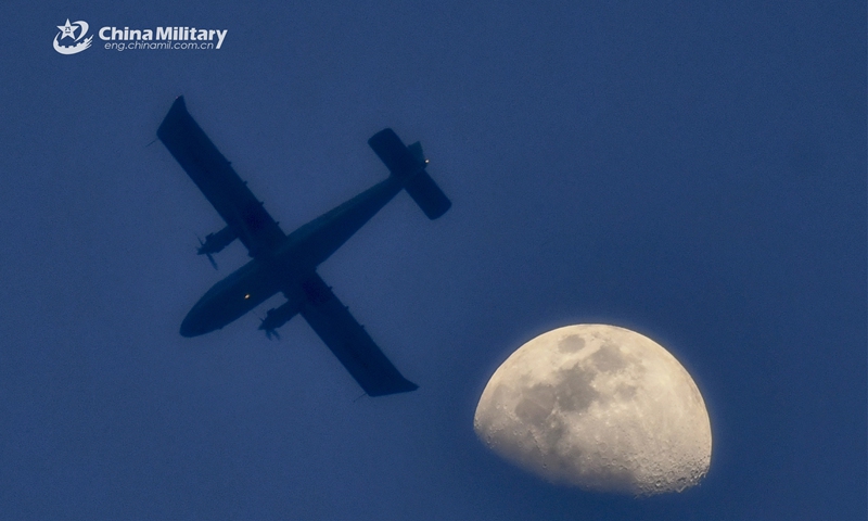 A Y-12 transport aircraft attached to an air transport brigade under the PLA Air Force's airborne troops flies high in moonlight during the intensive round-the-clock flight training recently. (eng.chinamil.com.cn/Photo by Li Zhuojun)