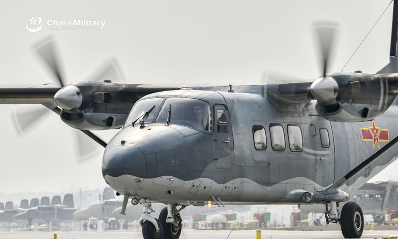 A Y-12 transport aircraft attached to an air transport brigade under the PLA Air Force's airborne troops taxies before takeoff during the intensive round-the-clock flight training recently. (eng.chinamil.com.cn/Photo by Li Zhuojun)