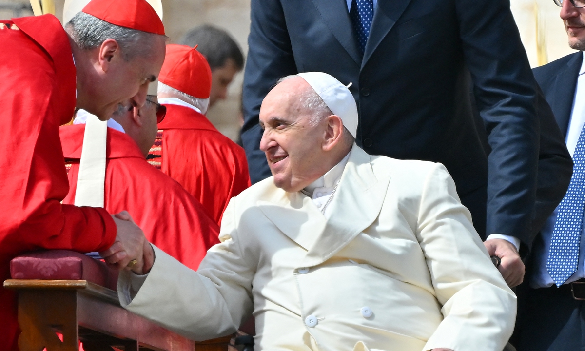 Pope Francis, seated in his wheelchair, goes to salute cardinals and bishops at the end of the Palm Sunday mass on April 2, 2023 at St. Peter's square in The Vatican. He oversaw the Palm Sunday ceremony in front of more than 30,000 faithful, followed by the Angelus prayer. He was admitted to Rome's Gemelli Hospital on March 29 with breathing difficulties, and later diagnosed with bronchitis.