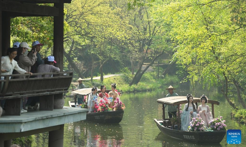 Tourists watch presentation of traditional Chinese clothing Hanfu in Xixi Wetland in Hangzhou, capital of east China's Zhejiang Province, April 2, 2023. Lovers of traditional Chinese clothing Hanfu gathered here for a flower fairies festival to celebrate the coming of spring.(Photo: Xinhua)