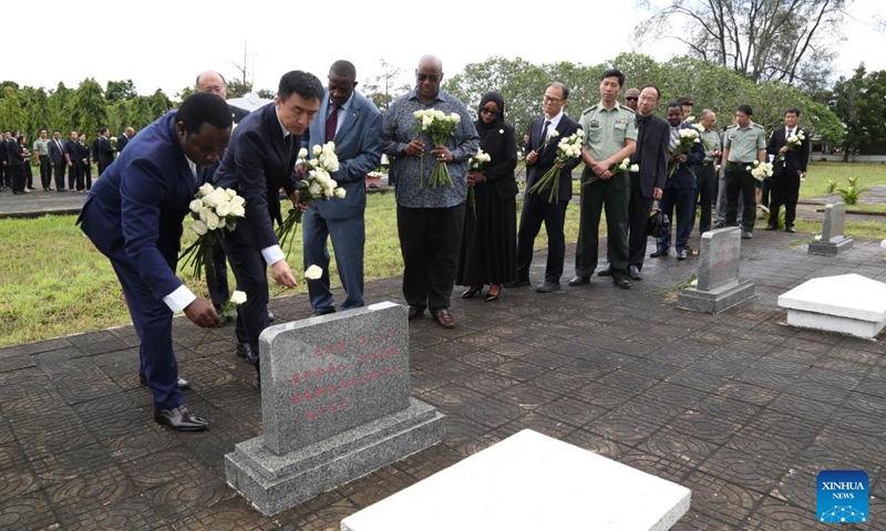 People lay flowers during a memorial ceremony at the Chinese experts' cemetery at Pugu on the outskirts of Dar es Salaam, Tanzania, on April 3, 2023. Tanzanian senior government officials on Monday joined the Chinese community living in the country at the Tomb-Sweeping Day memorial ceremony for Chinese experts who died during the construction of the Tanzania-Zambia Railway and the implementation of other China-Tanzania cooperation projects. (Photo:Xinhua)