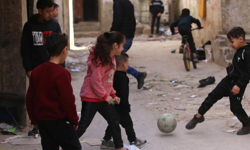 Palestinian children play in an alley at Balata refugee camp on the occasion of Palestinian Children's Day near the West Bank city of Nablus, April 5, 2023. (Photo by Nidal Eshtayeh/Xinhua)