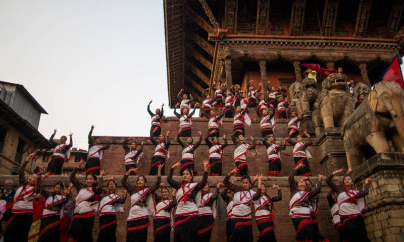 Girls in traditional attire perform during a musical event to mark the upcoming Nepali New Year at Bhaktapur Durbar Square in Bhaktapur, Nepal, April 9, 2023. (Photo by Sulav Shrestha/Xinhua)