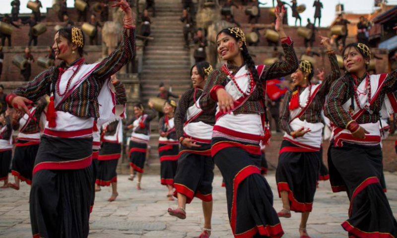 Girls in traditional attire perform during a musical event to mark the upcoming Nepali New Year at Bhaktapur Durbar Square in Bhaktapur, Nepal, April 9, 2023. (Photo by Sulav Shrestha/Xinhua)