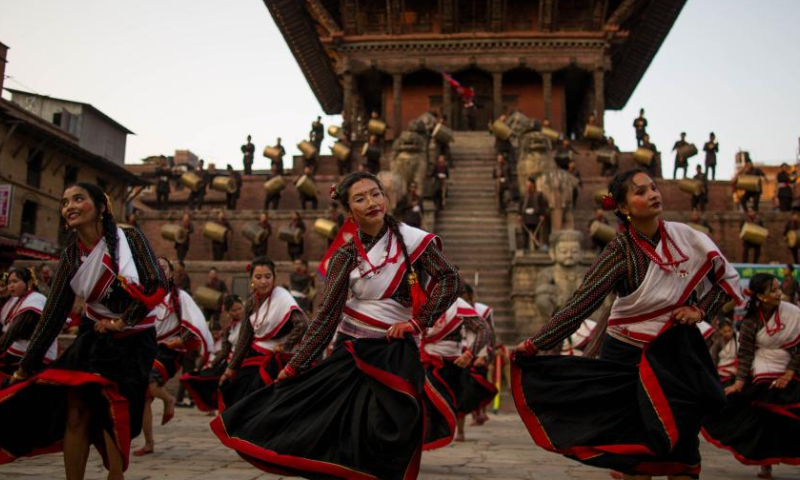 Girls in traditional attire perform during a musical event to mark the upcoming Nepali New Year at Bhaktapur Durbar Square in Bhaktapur, Nepal, April 9, 2023. (Photo by Sulav Shrestha/Xinhua)