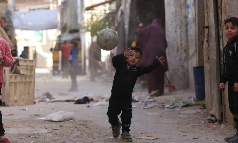 Palestinian children play in an alley in Balata refugee camp on the occasion of Palestinian Children's Day near the West Bank city of Nablus, April 5, 2023. (Photo by Nidal Eshtayeh/Xinhua)