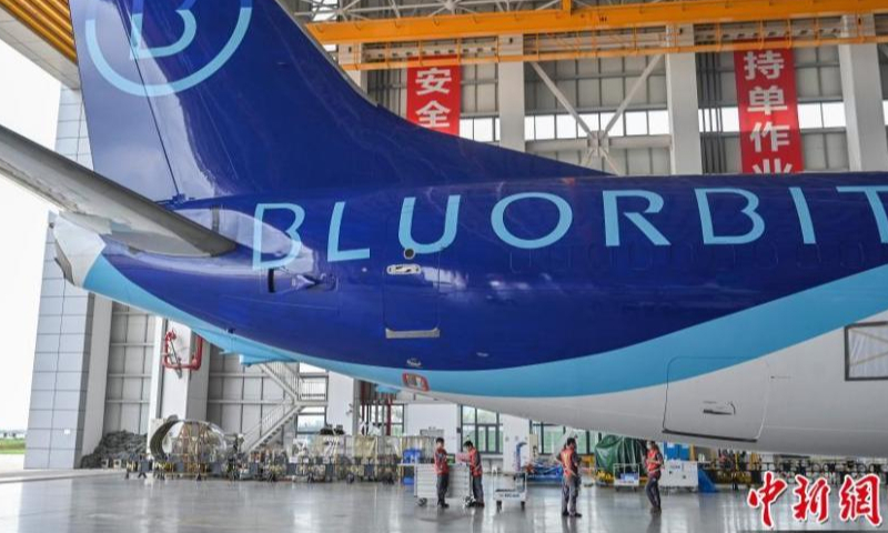 Staff members make preparation work at the painting hangar of the Hainan Free Trade Port One-stop Aircraft Maintenance Industry Base in Haikou, south China's Hainan Province, April 6, 2023. (Photo: China News Service/Luo Yunfei)