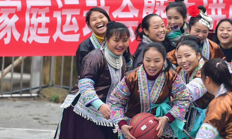 Women play basketball in Wuying village of Rongshui Miao Autonomous Prefecture, south China's Guangxi Zhuang Autonomous Region, Dec. 25, 2019. Basketball has long been popular in Wuying Village. In the past, the villagers played on a dirt court. The local government has been upgrading the infrastruture in recent years, including building a new basketball court of concrete. Now the sport becomes even more popular among the villagers, especially the kids. The village organizes basketball matches to celebrate festivals. (Xinhua/Huang Xiaobang)