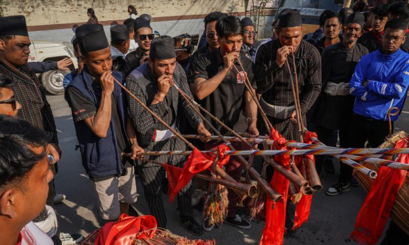 Newar men in traditional attire play a traditional musical instrument during a cultural festival in Kathmandu, Nepal, April 9, 2023. (Photo by Hari Maharjan/Xinhua)