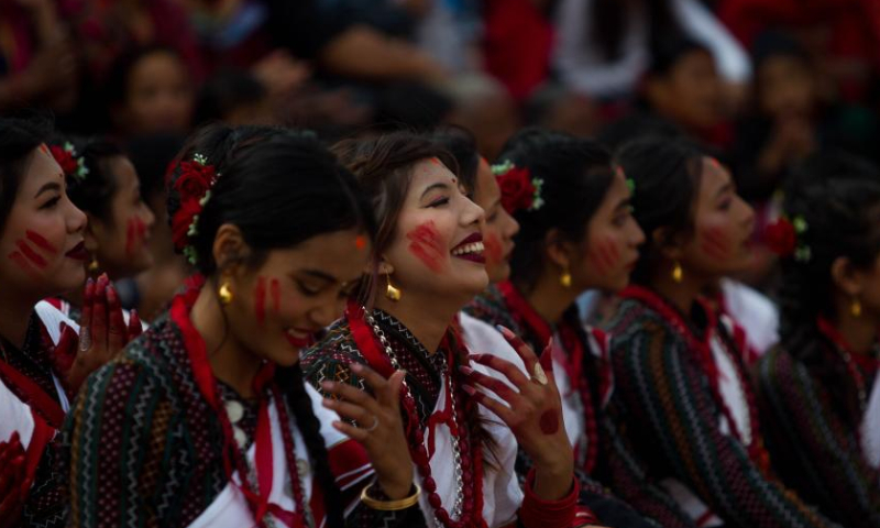 Girls in traditional attire perform during a musical event to mark the upcoming Nepali New Year at Bhaktapur Durbar Square in Bhaktapur, Nepal, April 9, 2023. (Photo by Sulav Shrestha/Xinhua)